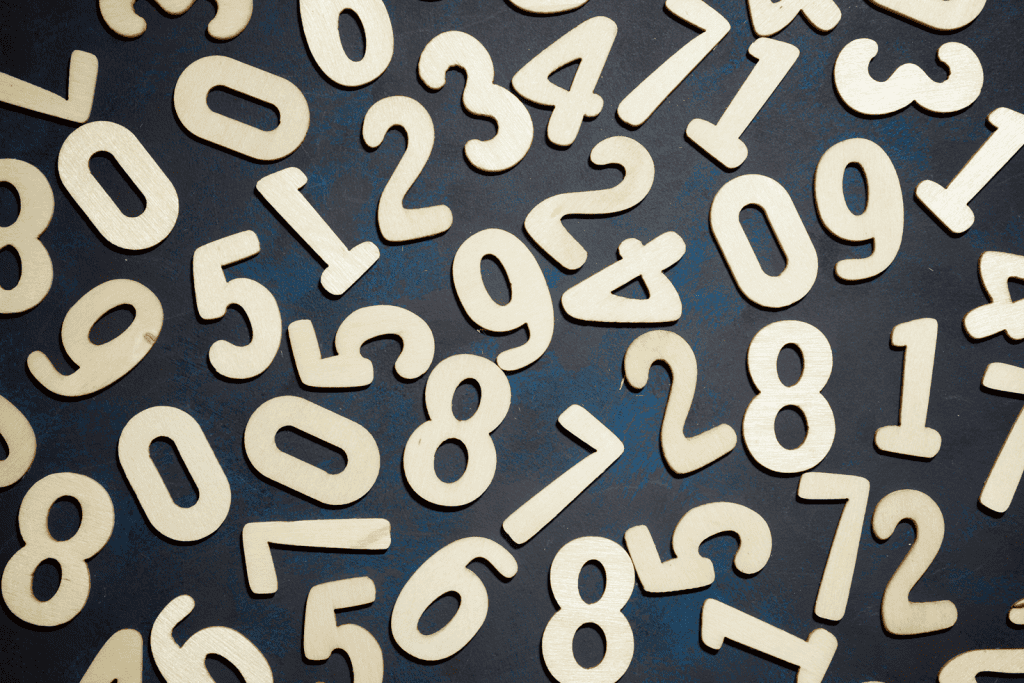 Numerical wooden figures, symbols representing spirituality and numerology, concepts central to personal development and spiritual journey.